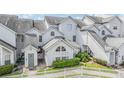 Charming townhome with light gray facade, well-manicured landscaping, and a white picket fence for added curb appeal at 12233 Armenia Gables Cir # 12233, Tampa, FL 33612