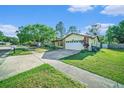 Exterior view of a home with a two-car garage and mature trees at 1349 Foxboro Dr, Brandon, FL 33511