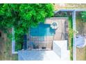 Aerial view of a backyard with a screened-in pool and spa surrounded by a privacy fence at 1510 Rushgrove Cir, Dover, FL 33527