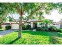 Charming single-story home featuring a well-maintained lawn and a two-car garage at 1510 Rushgrove Cir, Dover, FL 33527