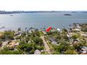 Aerial view showcases the property's location with waterfront access, nearby docks, and lush greenery at 1748 Sunset Dr, Clearwater, FL 33755