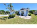 Charming single-story home boasts a well-manicured lawn, front-entry garage, and delightful landscaping at 2113 E Del Webb Blvd, Sun City Center, FL 33573