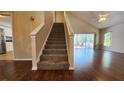 View of the living room and carpeted stairs leading up to the home's second level at 2113 E Del Webb Blvd, Sun City Center, FL 33573