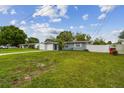 Charming single-story home with a lush front yard, driveway and attached garage at 2401 Havana Dr, Clearwater, FL 33764