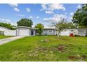 Charming single-story home with a lush front yard and attached garage at 2401 Havana Dr, Clearwater, FL 33764