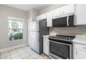 Kitchen featuring white cabinets, stainless steel appliances, and tile flooring at 273 Countryside Key Blvd, Oldsmar, FL 34677