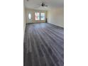 Spacious living room featuring luxury vinyl plank flooring, ceiling fan, and natural light at 304 4Th Sw Ave, Largo, FL 33770