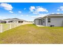 The spacious backyard features a white picket fence and peaceful neighborhood views at 37587 Mackenzie Dr, Zephyrhills, FL 33540