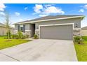 Charming single-Gathering home features stone accents, lush landscaping, and a welcoming two-car garage at 37587 Mackenzie Dr, Zephyrhills, FL 33540