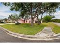 Well-maintained single-Gathering house featuring a lush green lawn with mature trees at 502 36Th W St, Palmetto, FL 34221