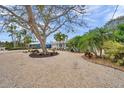 A long driveway and large shade tree lead to this home with meticulously landscaped grounds at 504 69Th St, Holmes Beach, FL 34217