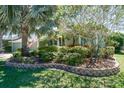 Beautiful landscaping surrounds this house, with an American flag displayed at 5269 Karlsburg Pl, Palm Harbor, FL 34685