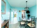 Cozy dining room with a glass table and black metal chairs at 5575 Gulf Blvd # 421, St Pete Beach, FL 33706