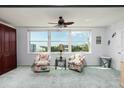 Bright living room features two patterned armchairs and large windows with city views at 5575 Gulf Blvd # 421, St Pete Beach, FL 33706