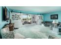 Spacious living room with sliding barn doors and coastal decor, offering a relaxing atmosphere at 5575 Gulf Blvd # 421, St Pete Beach, FL 33706