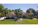 Charming single-story home featuring lush landscaping, a well-manicured lawn, and a symmetrical facade at 5807 Thoreau Pl, Lithia, FL 33547