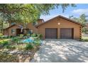 Charming log-cabin-style home with a two-car garage and well-manicured landscaping at 7157 Quail Hollow Blvd, Wesley Chapel, FL 33544