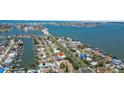 Expansive aerial shot reveals the home's proximity to the water and the vibrant coastal community at 7919 Causeway S Blvd, St Petersburg, FL 33707