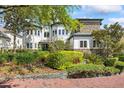 Charming front yard with lush greenery, brick walkway, and a beautifully landscaped entrance at 1058 Roundstone Pl, Palm Harbor, FL 34683