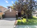 Charming two-story home featuring a well-manicured lawn and a two-car garage at 12215 Adventure Dr, Riverview, FL 33579