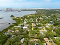 Aerial view showcasing the property's location near the water and surrounding neighborhood amenities at 12893 Poinsettia Ave, Seminole, FL 33776