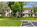 Well-maintained condo complex with lush landscaping and ample parking at 129 Lakeview Way, Oldsmar, FL 34677