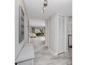Bright hallway with wood-look tile flooring and storage closet at 129 Lakeview Way, Oldsmar, FL 34677