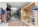 Workout room featuring a sauna, weights, and a tv for the ultimate home fitness experience at 13102 Foxtail Fern Dr, Riverview, FL 33579