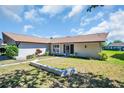 Well-maintained single-story home with mature landscaping and a welcoming front entrance at 1657 Glengarry Dr, Palm Harbor, FL 34684