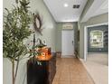 A welcoming foyer with tile flooring, neutral walls, and decorative furnishings, creating a warm entry at 18243 Cypress Bay Pkwy, Land O Lakes, FL 34638