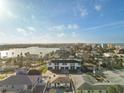 Wide aerial perspective of the multi-unit property situated near a body of water, offering panoramic views of the surrounding landscape at 187 145Th E Ave # 3, Madeira Beach, FL 33708