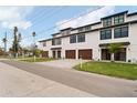 Modern townhouse exteriors with white siding and dark trim details at 187 145Th E Ave # 3, Madeira Beach, FL 33708