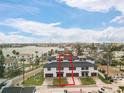 Townhouse complex exterior highlighting facade, individual garages, and a well-maintained lawn under a bright sky at 187 145Th E Ave # 3, Madeira Beach, FL 33708