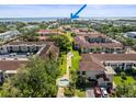 Beautiful view of the complex surrounded by mature trees with multiple residential buildings at 19029 Us Highway 19 N # 9-407, Clearwater, FL 33764