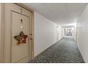 Hallway view leading to Unit 407 adorned with a star decoration on the door at 19029 Us Highway 19 N # 9-407, Clearwater, FL 33764