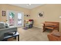 Cozy living room with neutral carpet, comfortable furniture, and a sliding glass door to the balcony at 1910 E Palm Ave # 11216, Tampa, FL 33605