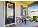 Inviting front porch features decorative brickwork and a cozy bench at 19325 Hawk Valley Dr, Tampa, FL 33647