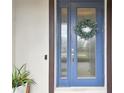 Stylish blue front door with glass panels and a welcoming decorative wreath at 19719 Cypress Bridge Dr, Odessa, FL 33556