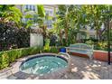 Inviting community hot tub surrounded by lush landscaping, offering a tranquil outdoor experience at 2410 W Azeele St # 228, Tampa, FL 33609