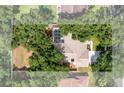 An aerial view of a home with a screened pool in a lush, green backyard at 2803 Bent Leaf Dr, Valrico, FL 33594