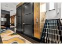 Elegant hallway featuring a staircase with striped carpet and an elevator for easy access to all floors at 325 2Nd N St, St Petersburg, FL 33701