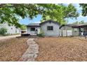 Comfortable one-story home with a pathway leading to the entrance, set in a tranquil residential environment at 4102 Haines N Rd, St Petersburg, FL 33703
