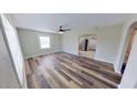 Spacious living room features hardwood floors, a modern ceiling fan, and access to other rooms at 4331 Fairfield S Ave, St Petersburg, FL 33711