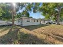 Well-kept single-story home with a boat parked nearby, showcasing outdoor space at 5302 S Himes Ave, Tampa, FL 33611