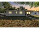 Charming single-story home with a well-maintained lawn and cozy front porch at dusk at 5302 S Himes Ave, Tampa, FL 33611