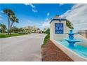 Welcoming entrance to Gulf Island Beach & Tennis Club with lush landscaping and water fountain at 5915 Sea Ranch Dr # 512, Hudson, FL 34667