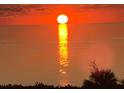 A mesmerizing sunset over the ocean, casting a warm, golden glow on the tranquil waters at 5915 Sea Ranch Dr # 512, Hudson, FL 34667