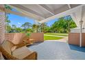 Inviting front porch with brick accents and a cozy seating area, perfect for enjoying the outdoor view at 6345 Dartmouth N Ave, St Petersburg, FL 33710