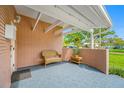 Welcoming covered front porch with brick detail features a cozy seating area and tiled flooring at 6345 Dartmouth N Ave, St Petersburg, FL 33710