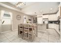 Bright dining area features modern lighting, tile flooring and ample natural light at 6477 Dutton Dr, Wesley Chapel, FL 33545